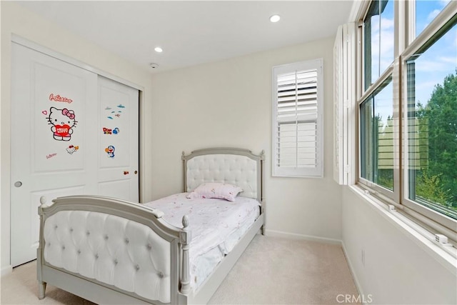 bedroom featuring baseboards, recessed lighting, light carpet, and multiple windows
