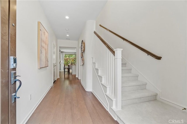 foyer entrance featuring stairway, wood finished floors, recessed lighting, and baseboards