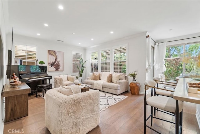 living area with recessed lighting and light wood finished floors