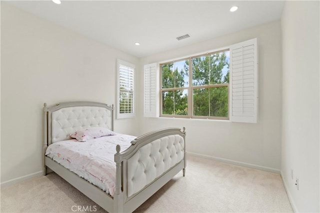 bedroom with carpet, visible vents, and baseboards