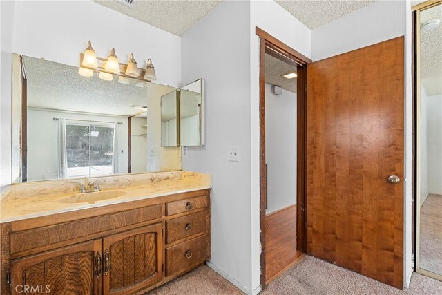 bathroom featuring vanity and a textured ceiling
