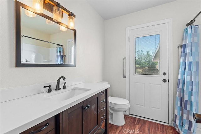 full bathroom with wood finished floors, vanity, a shower with shower curtain, and toilet