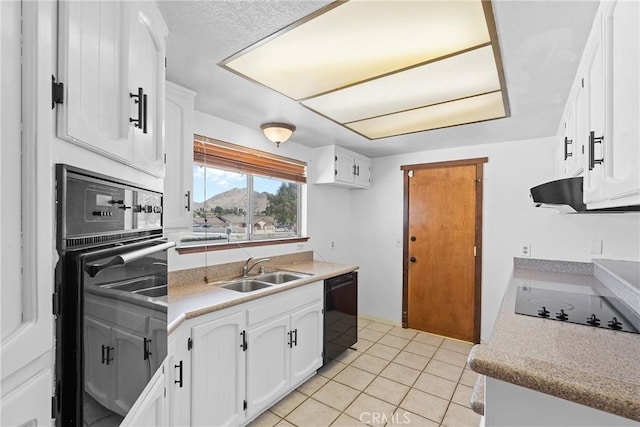kitchen with white cabinets, light countertops, light tile patterned floors, a sink, and black appliances