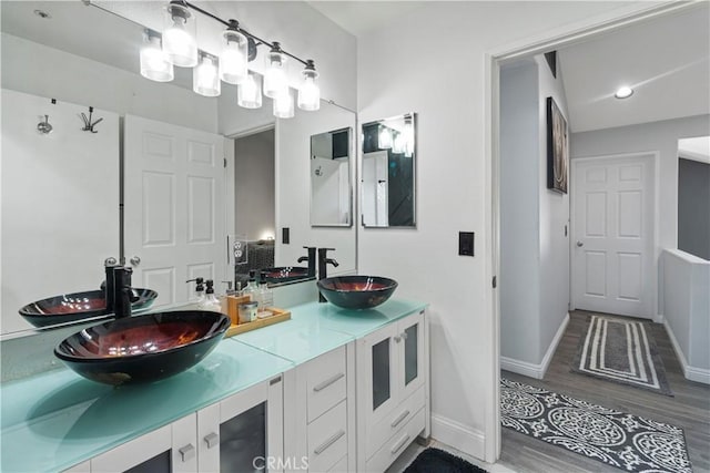 13656 Dronfield Ave, Sylmar, CA 91342 - bathroom with double vanity, a sink, and wood finished floors