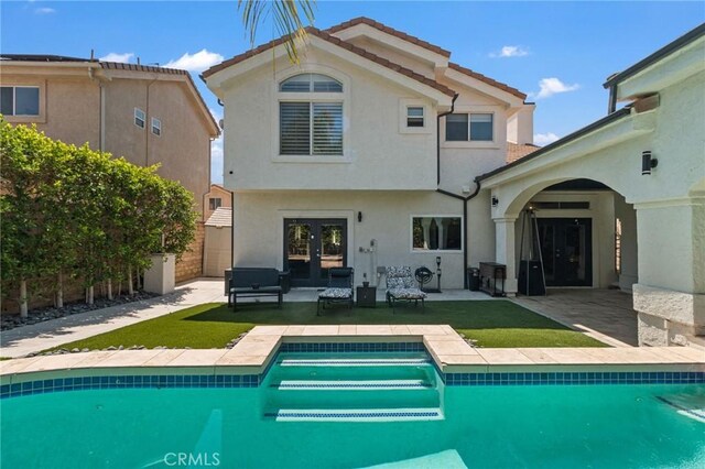 13656 Dronfield Ave, Sylmar, CA 91342 - rear view of house featuring fence, a patio, an outdoor pool, stucco siding, and french doors