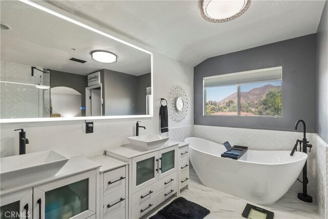 13656 Dronfield Ave, Sylmar, CA 91342 - full bathroom with double vanity, a freestanding tub, a sink, and marble finish floor