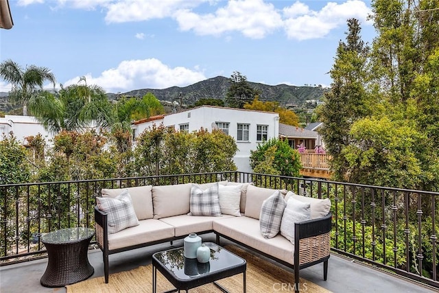 balcony featuring an outdoor living space and a mountain view