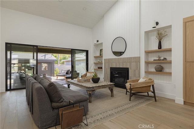459 E 18th St, Costa Mesa, CA 92627 - living area featuring high vaulted ceiling, light wood-type flooring, built in features, and a fireplace