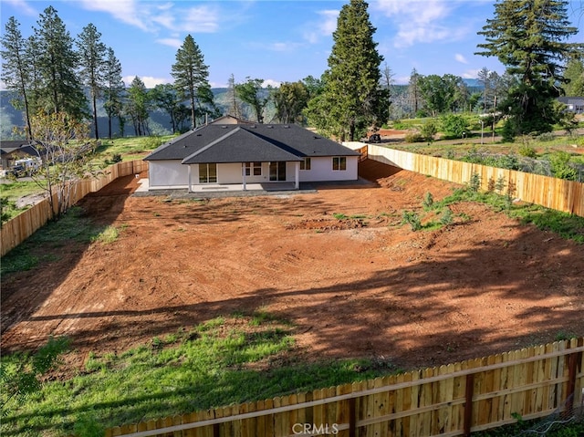 back of property featuring a patio and a fenced backyard