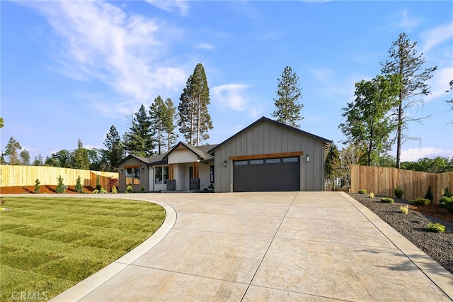 view of front of house featuring a garage, fence, board and batten siding, and driveway
