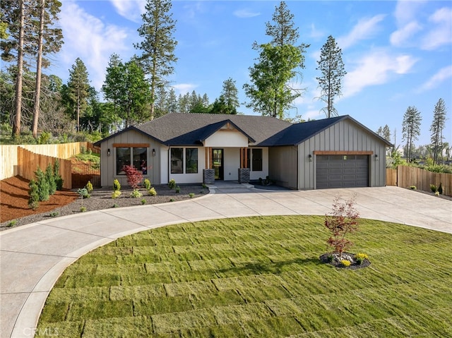 ranch-style home with a front yard, a garage, board and batten siding, concrete driveway, and fence