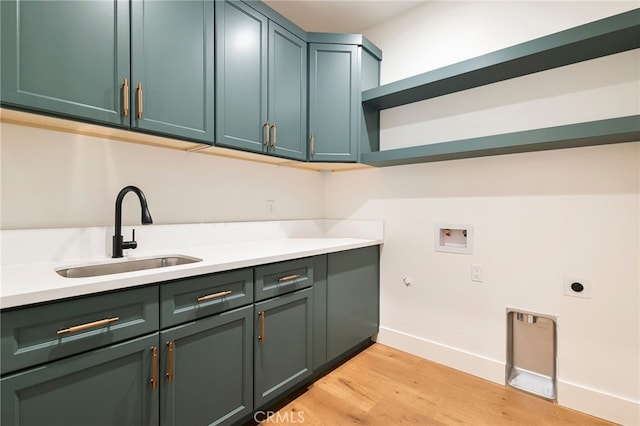 washroom with washer hookup, light wood-style flooring, a sink, electric dryer hookup, and cabinet space