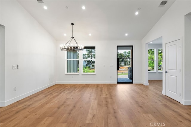 unfurnished dining area featuring recessed lighting, a chandelier, light wood-type flooring, visible vents, and high vaulted ceiling