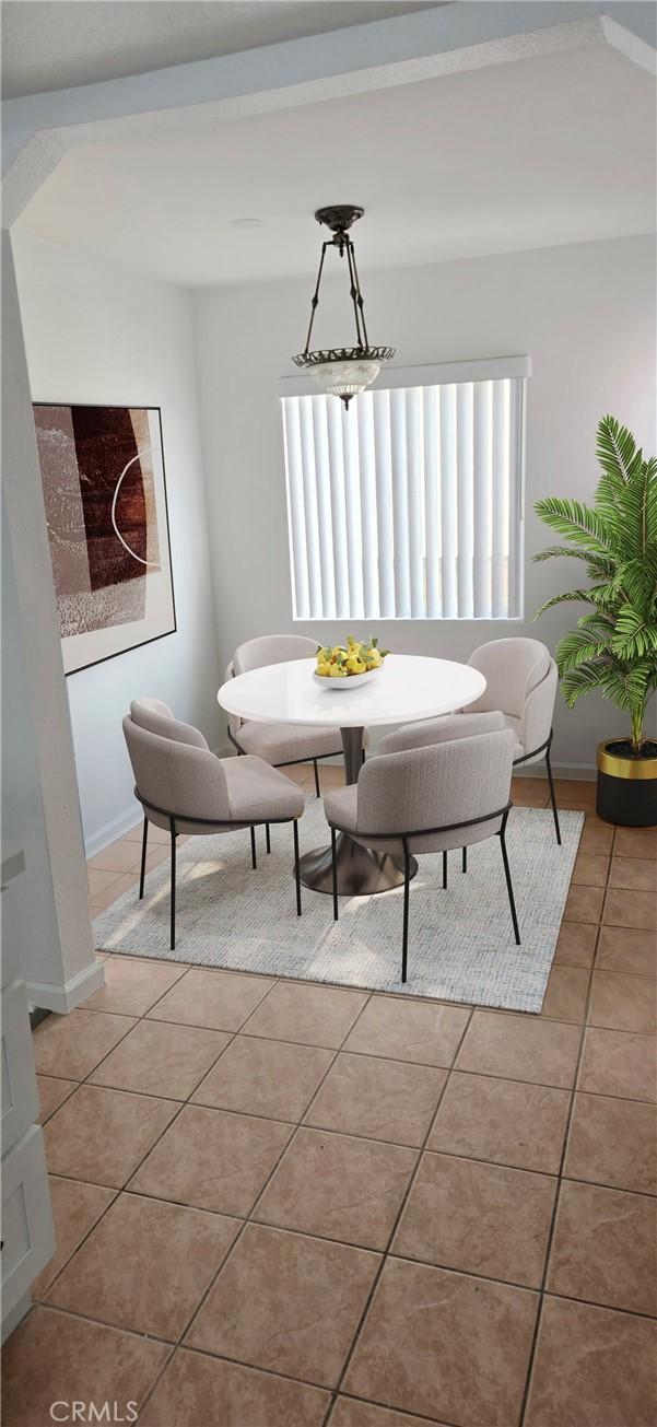 dining area with light tile patterned flooring and baseboards