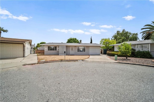 ranch-style home featuring a garage and driveway