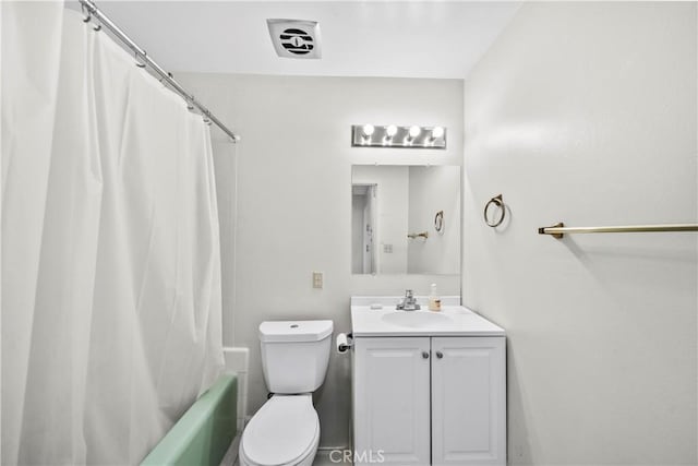 bathroom featuring shower / tub combo, toilet, and vanity