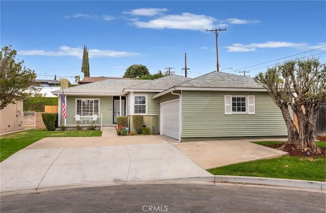 ranch-style home with a garage, covered porch, roof with shingles, concrete driveway, and fence