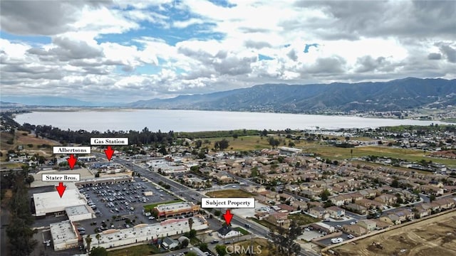 aerial view featuring a water and mountain view