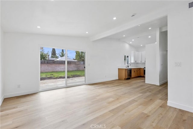 1758 Bainbridge St, Pomona, CA 91766 - unfurnished living room with visible vents, a sink, baseboards, recessed lighting, and lofted ceiling with beams