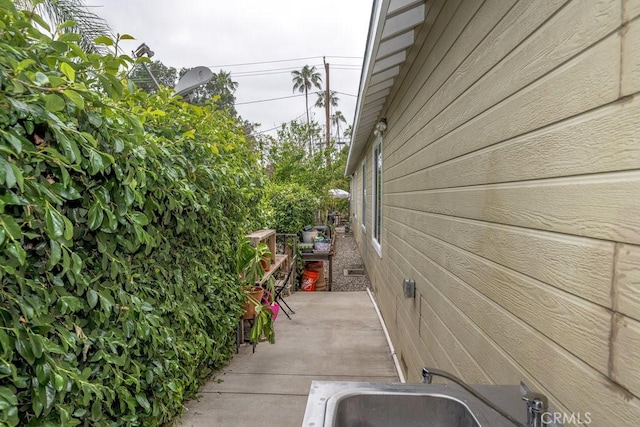 view of home's exterior with a patio and a sink