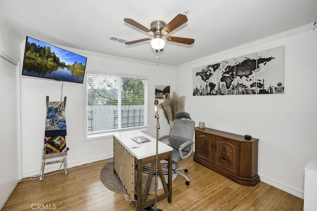 office with light wood finished floors, visible vents, ornamental molding, baseboards, and ceiling fan