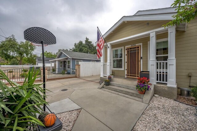 exterior space with fence and covered porch