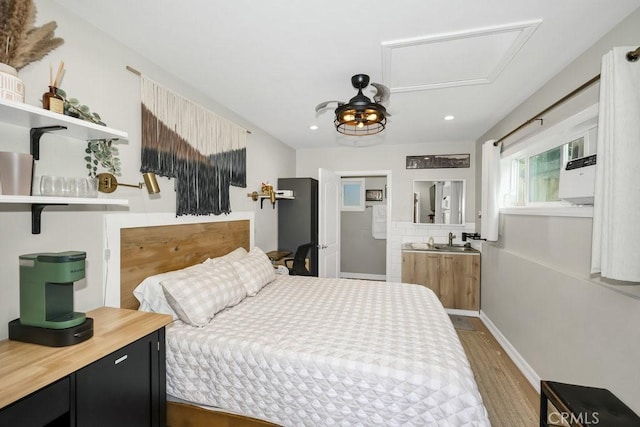 bedroom featuring wood finished floors and recessed lighting