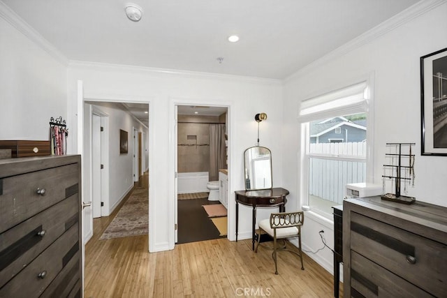 interior space with baseboards, crown molding, and light wood-style flooring