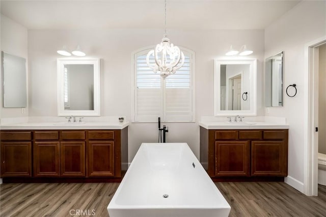 30461 Savoie St, Murrieta, CA 92563 - full bath with a sink, toilet, wood finished floors, and two vanities