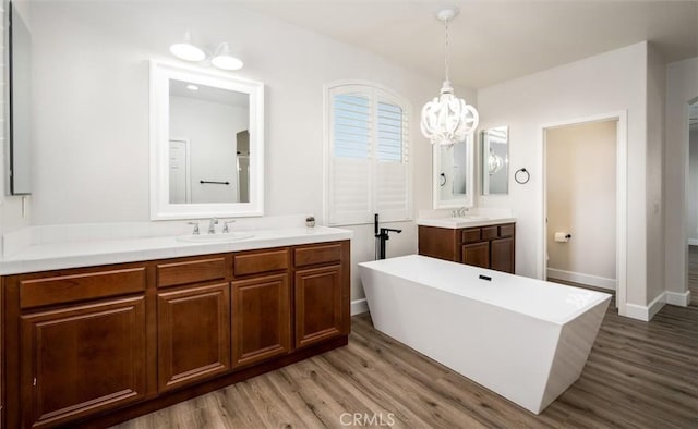 30461 Savoie St, Murrieta, CA 92563 - bathroom with a sink, a soaking tub, wood finished floors, and a chandelier
