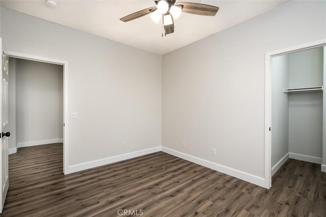 30461 Savoie St, Murrieta, CA 92563 - unfurnished bedroom with a ceiling fan, dark wood-style flooring, baseboards, a closet, and a spacious closet
