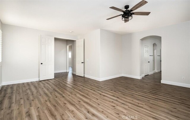 30461 Savoie St, Murrieta, CA 92563 - empty room with baseboards, arched walkways, a ceiling fan, and wood finished floors