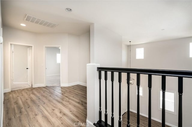 30461 Savoie St, Murrieta, CA 92563 - hall with visible vents, wood finished floors, baseboards, an upstairs landing, and recessed lighting