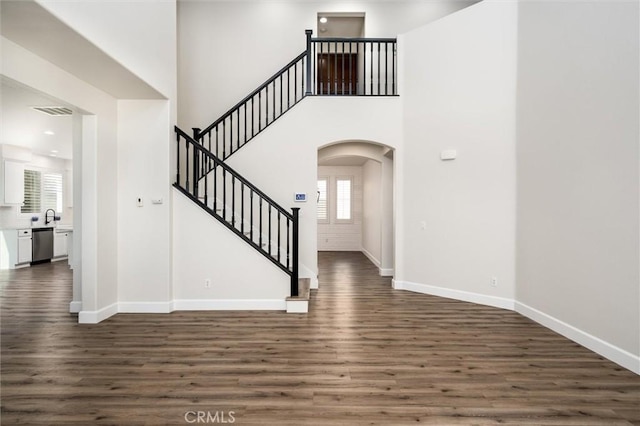 30461 Savoie St, Murrieta, CA 92563 - foyer entrance with arched walkways, dark wood-style floors, and a wealth of natural light