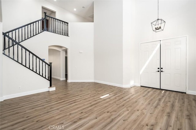 30461 Savoie St, Murrieta, CA 92563 - entryway featuring a towering ceiling, arched walkways, wood finished floors, stairway, and baseboards