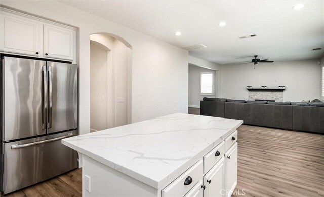 30461 Savoie St, Murrieta, CA 92563 - kitchen featuring a ceiling fan, a center island, wood finished floors, white cabinets, and freestanding refrigerator