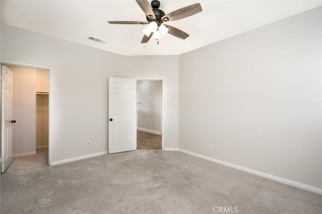 30461 Savoie St, Murrieta, CA 92563 - unfurnished bedroom with a walk in closet, a ceiling fan, visible vents, carpet floors, and baseboards