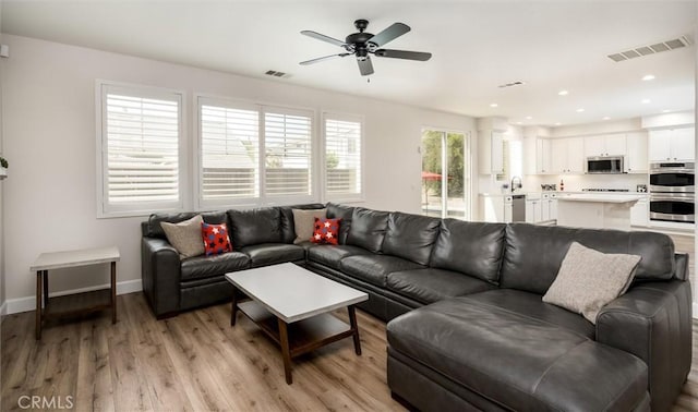 30461 Savoie St, Murrieta, CA 92563 - living room with a ceiling fan, baseboards, visible vents, and light wood-style floors