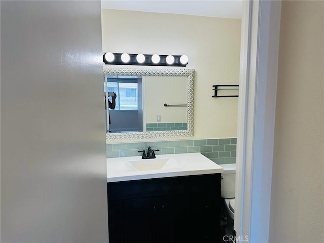 4219 La Pinata Unit 255, Oceanside, CA 92057 - bathroom with vanity, toilet, and tasteful backsplash