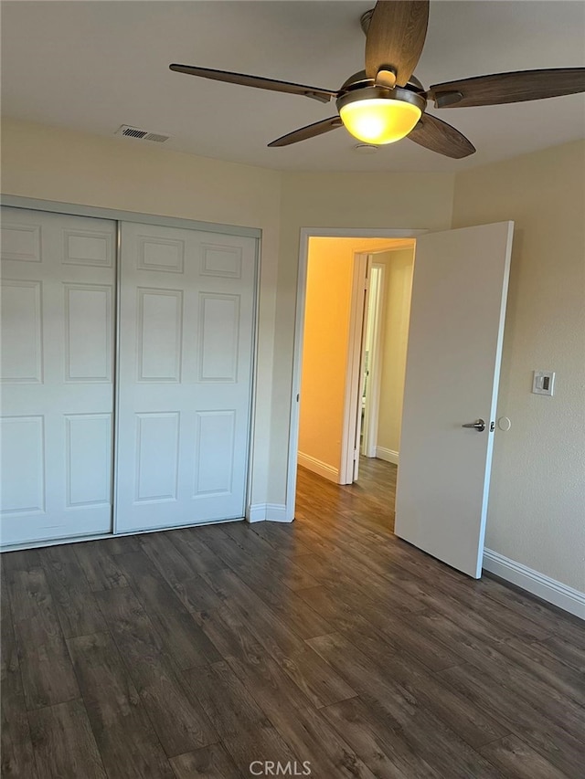 4219 La Pinata Unit 255, Oceanside, CA 92057 - unfurnished bedroom with baseboards, dark wood-style flooring, a closet, and ceiling fan