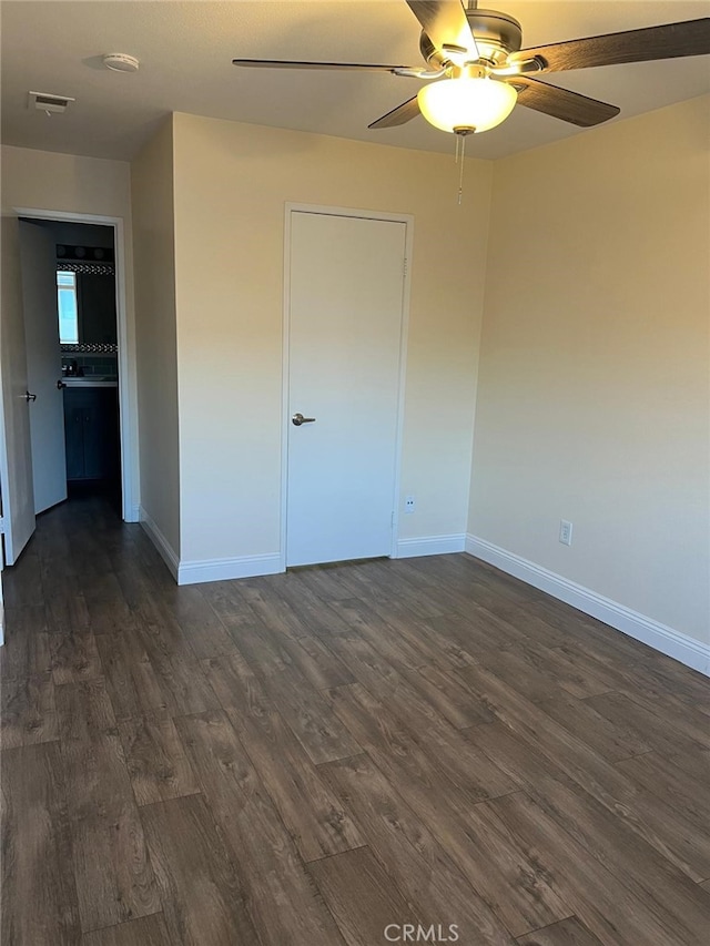 4219 La Pinata Unit 255, Oceanside, CA 92057 - unfurnished bedroom with dark wood-style flooring, baseboards, and ceiling fan