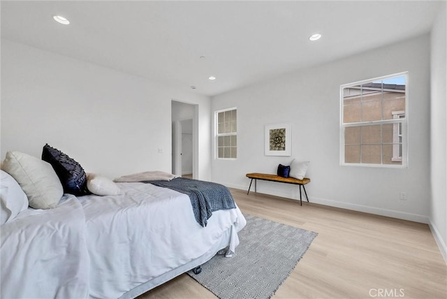 bedroom featuring recessed lighting, baseboards, and light wood-type flooring