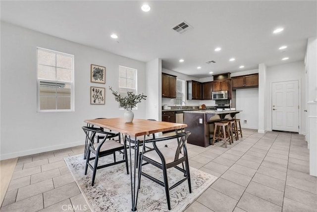 dining room with visible vents, baseboards, recessed lighting, and light tile patterned floors