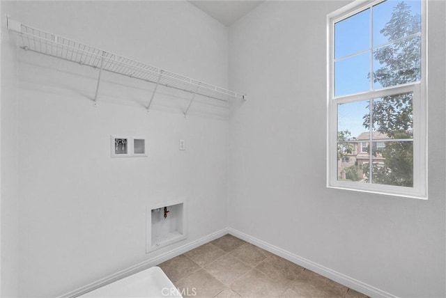 laundry area featuring baseboards, hookup for a washing machine, and laundry area