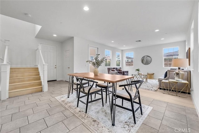 dining area with light tile patterned flooring, stairs, and recessed lighting