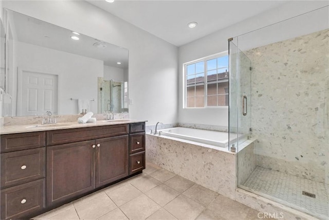 bathroom with tile patterned flooring, a bath, a sink, and a stall shower