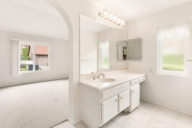 bathroom featuring baseboards, vanity, and tile patterned flooring