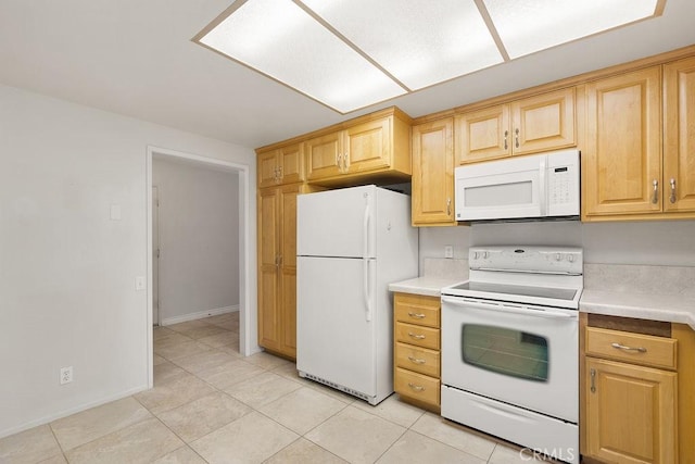 kitchen featuring light countertops, light brown cabinets, light tile patterned floors, white appliances, and baseboards