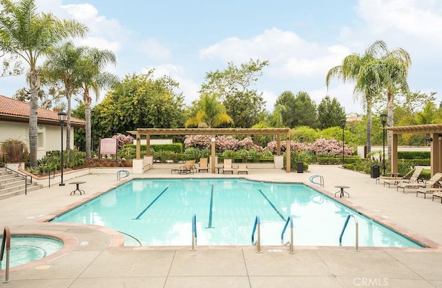 pool with a pergola and a patio area
