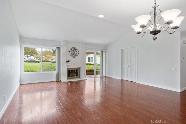 unfurnished living room featuring wood finished floors, a chandelier, and plenty of natural light